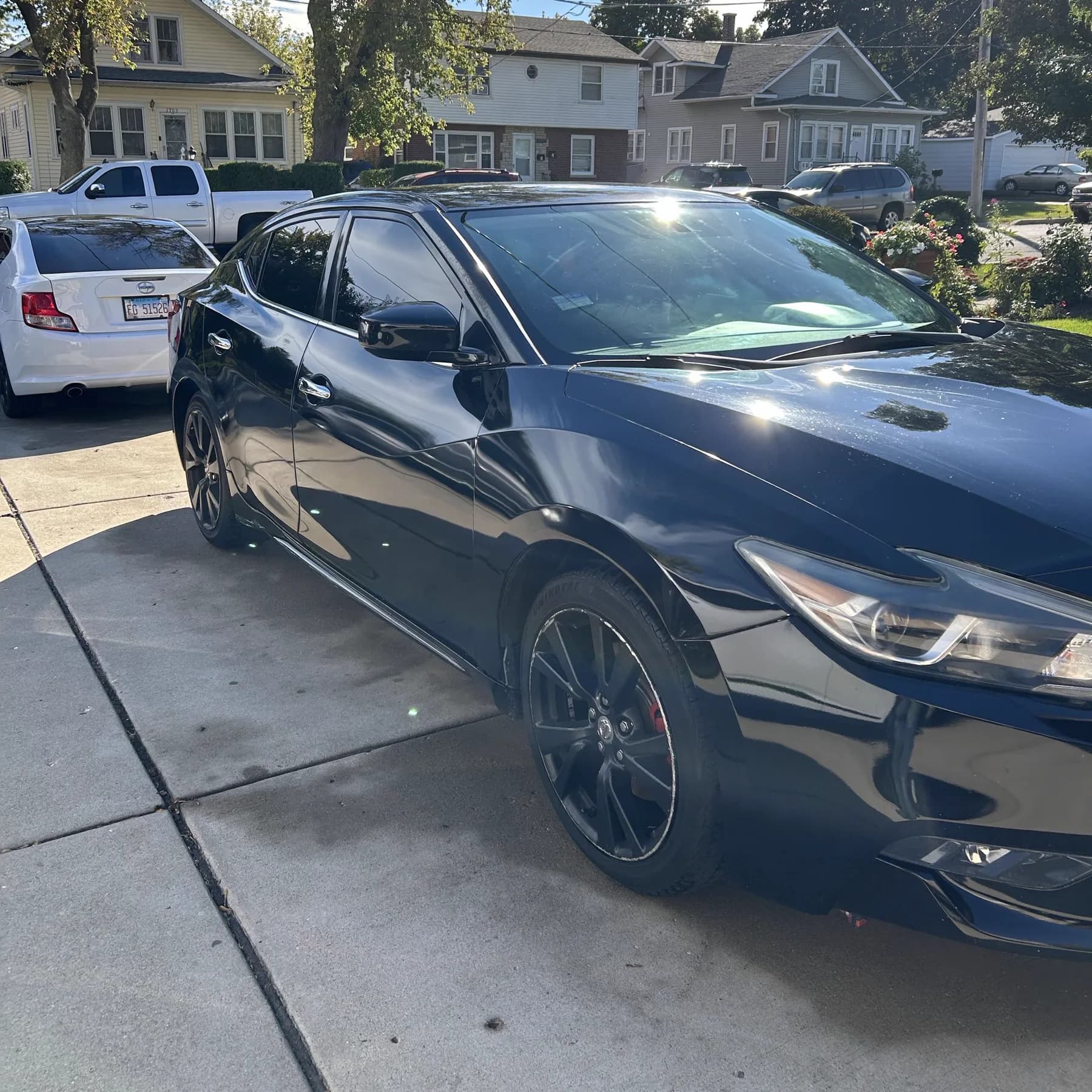 Dark sedan with a glossy exterior finish after detailing