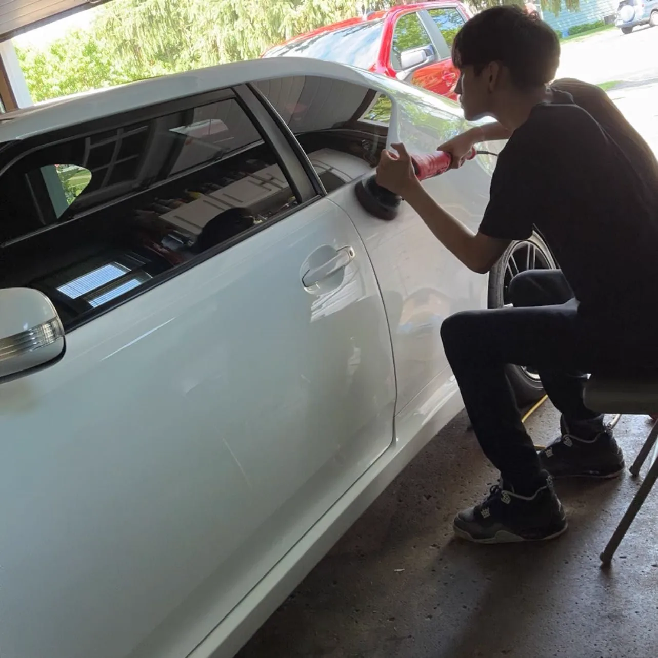 Detailing Rite operator polishing a white vehicle